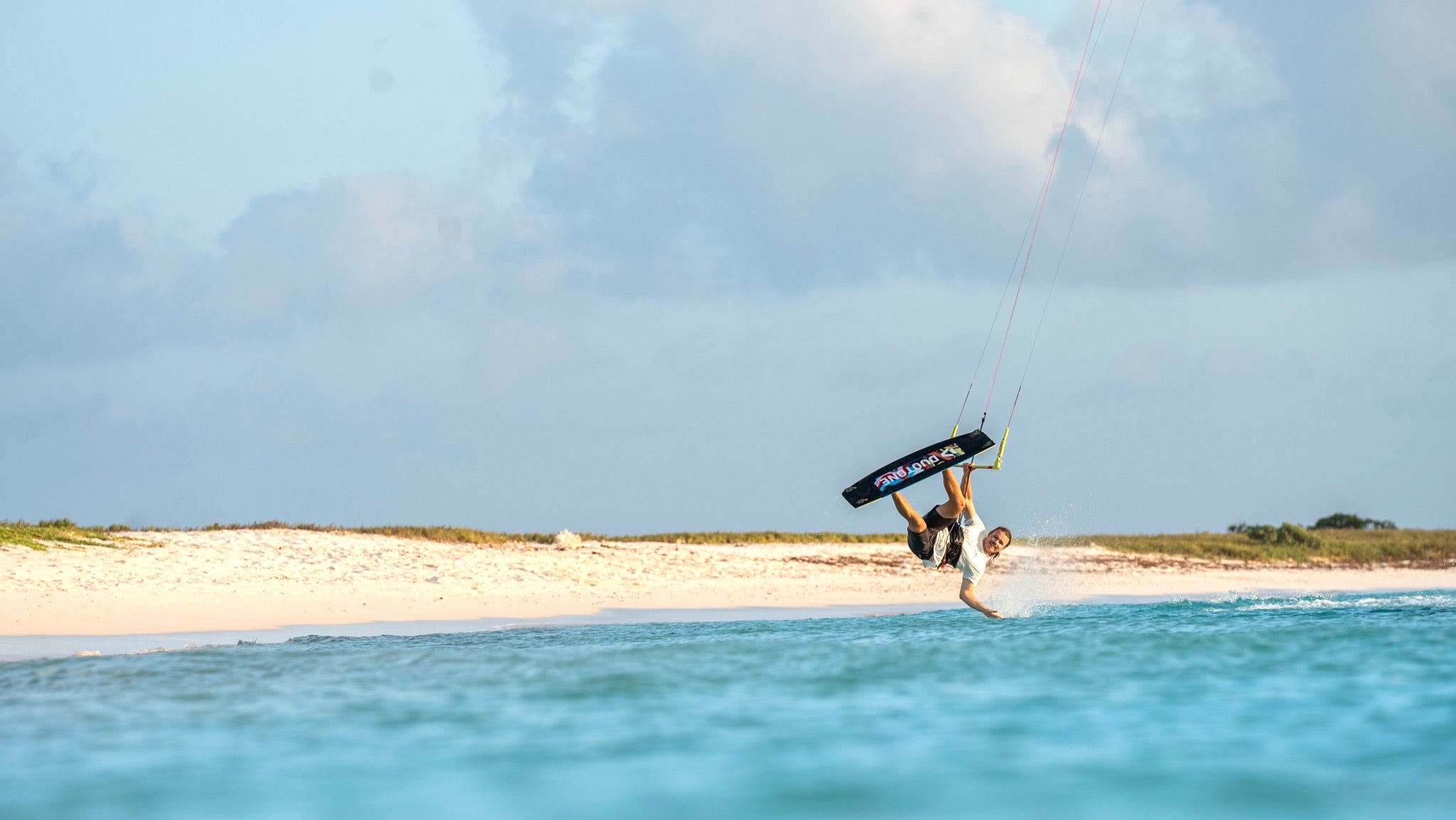 Drew doing a hand drag while kiteboarding